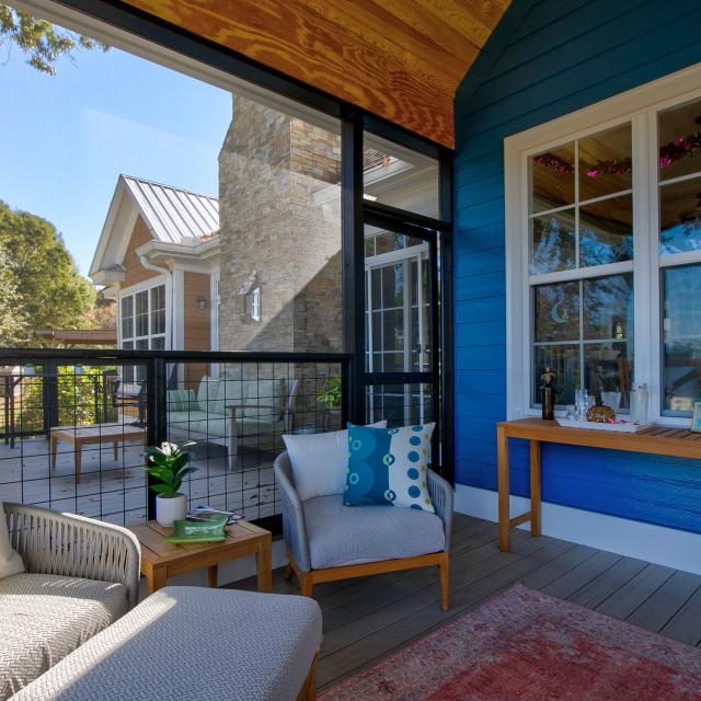 View of the inside of a screened in back porch facing the house. 