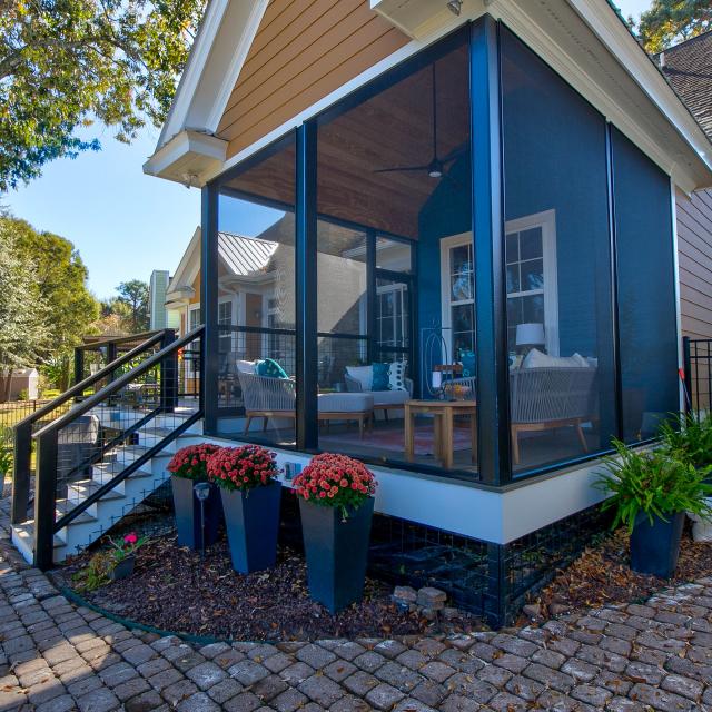 View of screened in back porch from the side. 