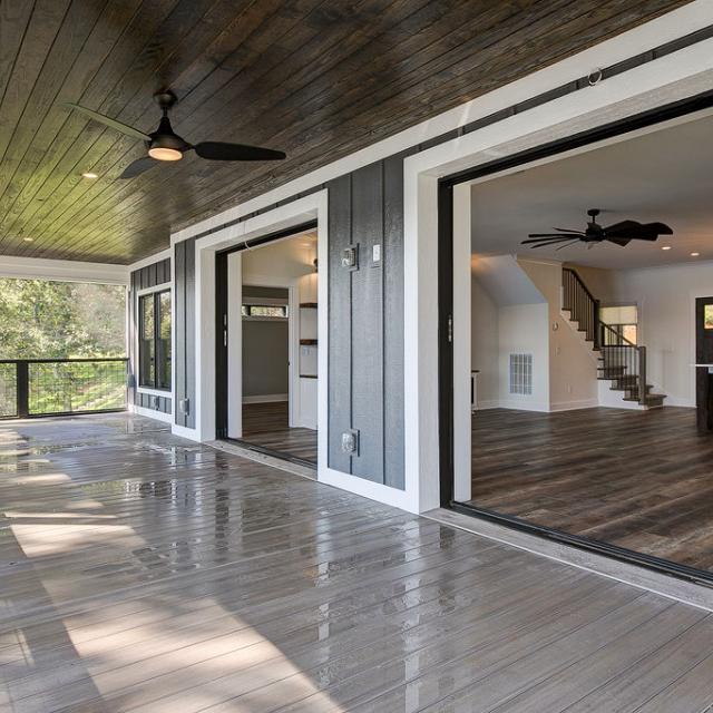 Large sliding glass doors on back porch of Rafter B custom lakeside home