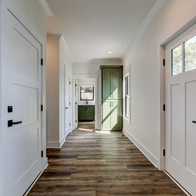 Interior hallway with built-in cabinetry and wooden floors