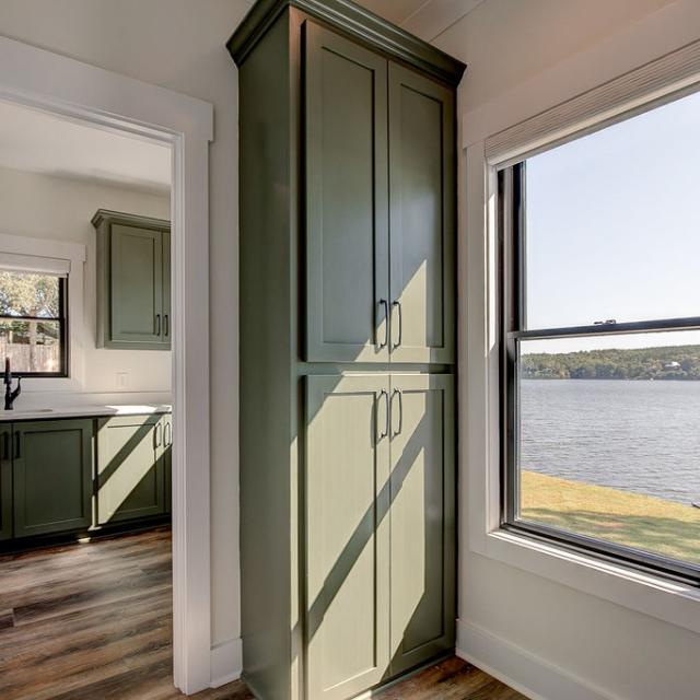 Interior hallway with built-in cabinetry and wooden floors