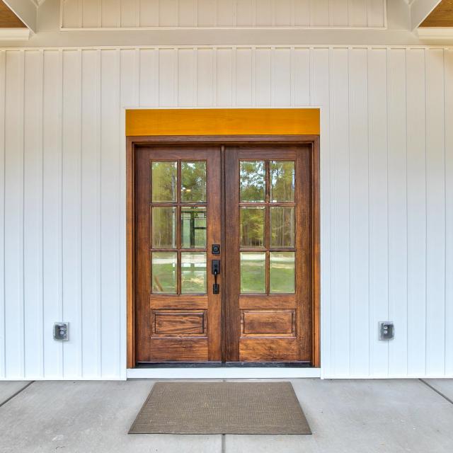 Wooden front door of white craftsman style home