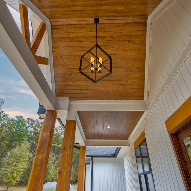 Wooden front porch ceiling with hanging light