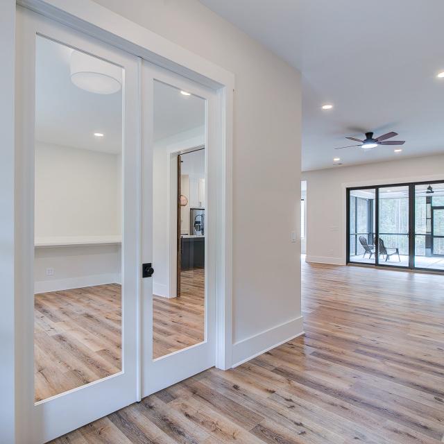 Entry with white walls and wooden floors