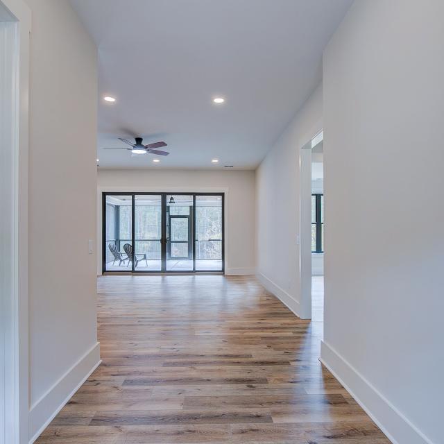 Entry with white walls and wooden floors