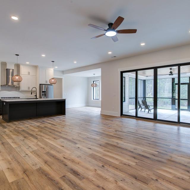 Room with white walls and wooden floors - Rafter B Construction custom home