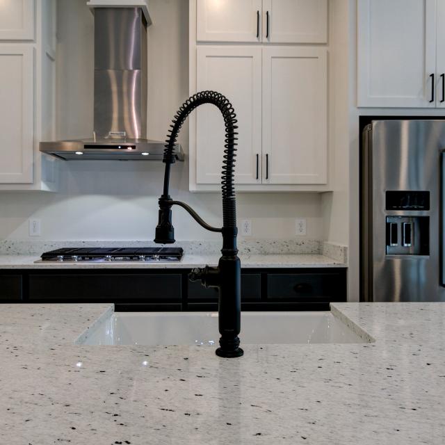 Close up of sink and marble countertops