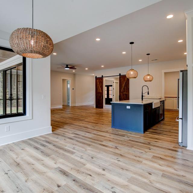 Dining room with wood floors, white walls and large windows