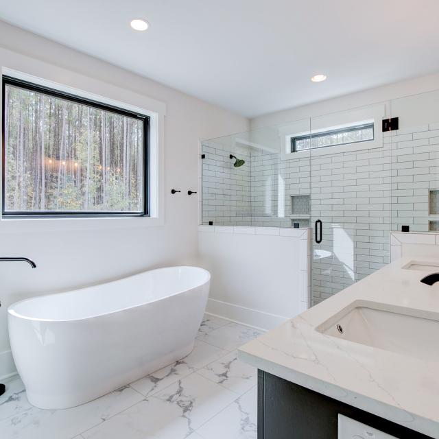 Ensuite bathroom with tub, double sinks and shower