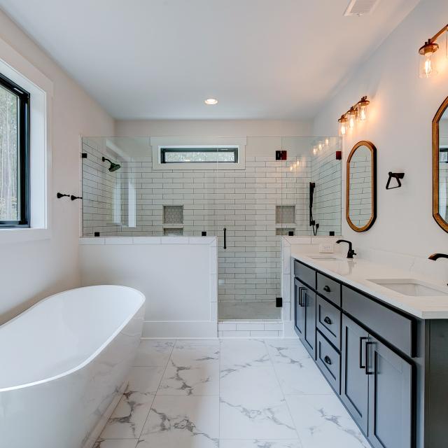 Ensuite bathroom with tub, double sinks and shower