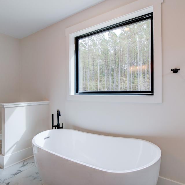 Ensuite bathroom with tub, double sinks and shower