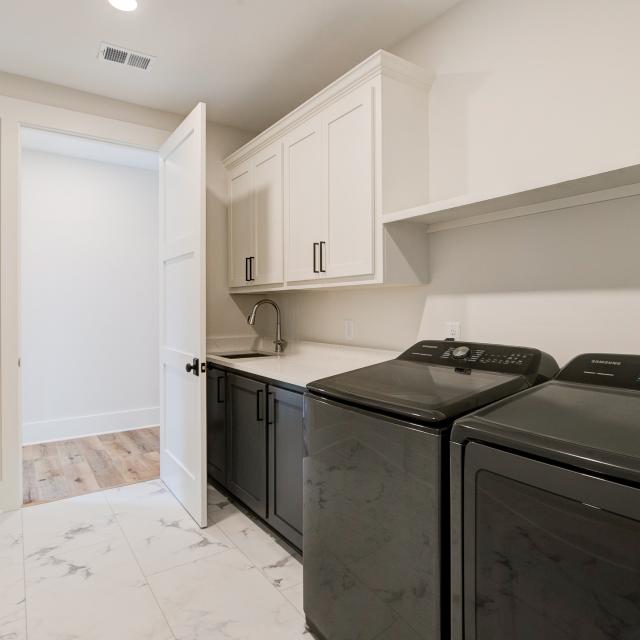 Laundry room with washer, dryer, and built in cabinets