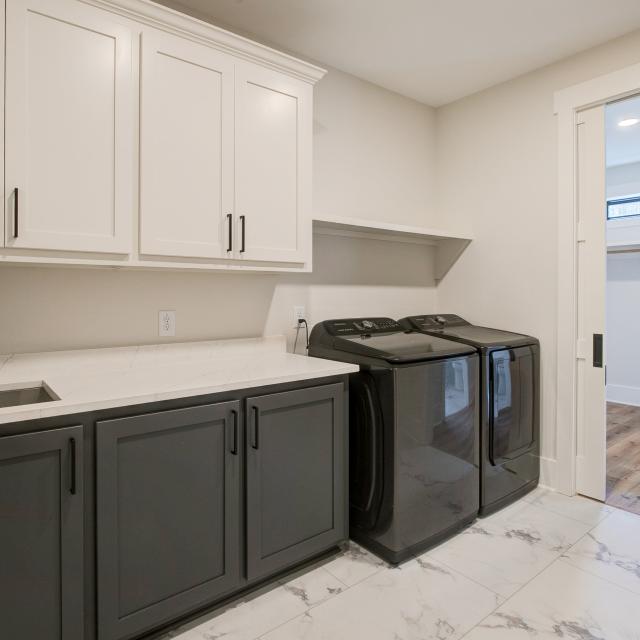 Laundry room with washer, dryer, and built in cabinets