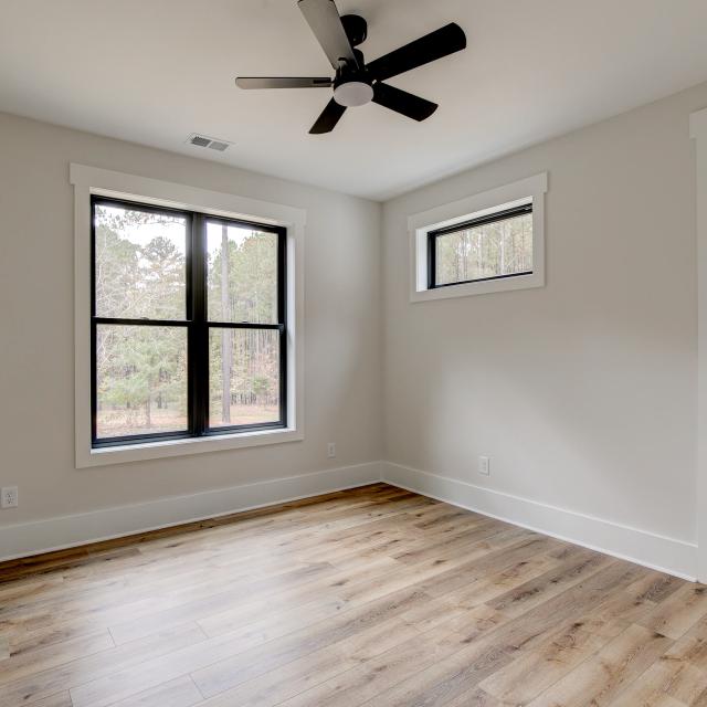 Room with wood floors, white walls and ceiling fan