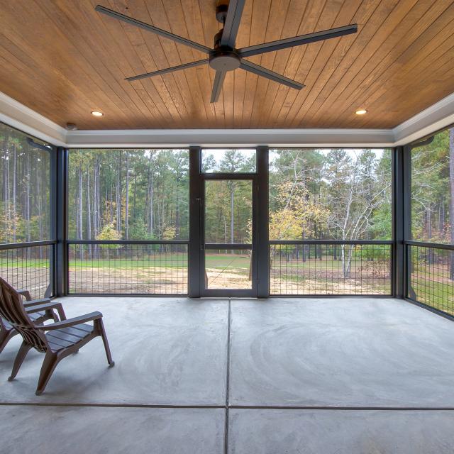 Screened back porch with wood ceiling and ceiling fan