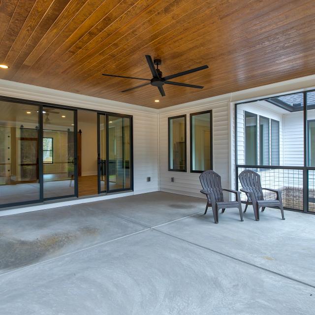 Screened back porch with wood ceiling and ceiling fan